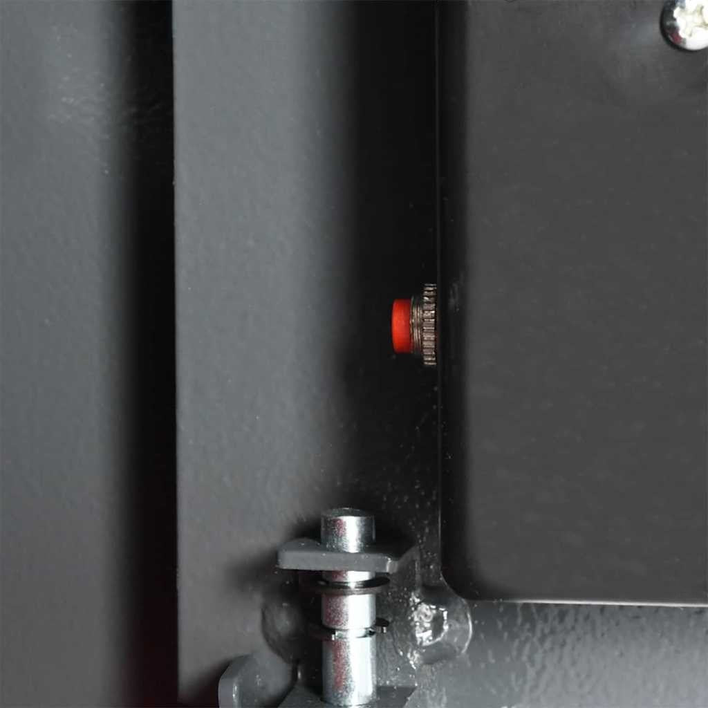 Détail intérieur du coffre-fort Mon Rempart en acier gris foncé avec bouton de réinitialisation rouge et mécanisme